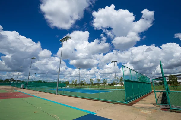 Prázdné venkovní tenisový kurt s modrou oblohou — Stock fotografie