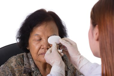 doctor bandaging patient's eye clipart