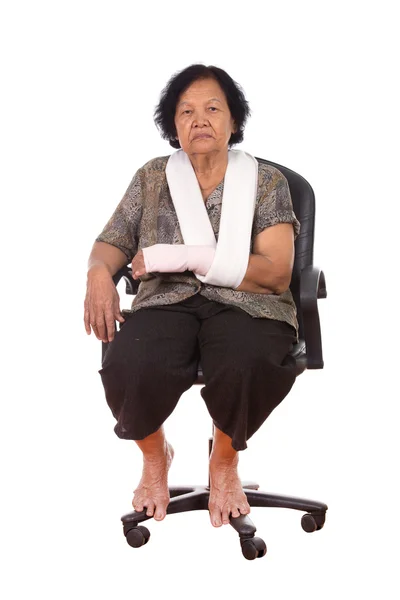 Senior woman with an injured arm wrapped in an Elastic Bandage — Stock Photo, Image