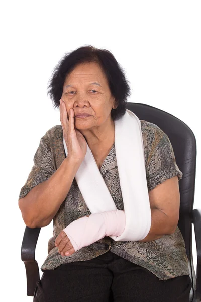 Senior woman with an injured arm wrapped in an Elastic Bandage — Stock Photo, Image