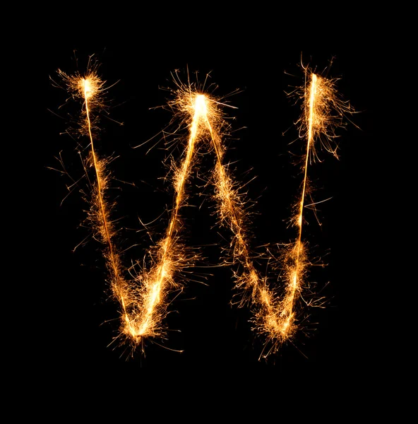 Sparkler firework light alphabet W at night — Stock Photo, Image