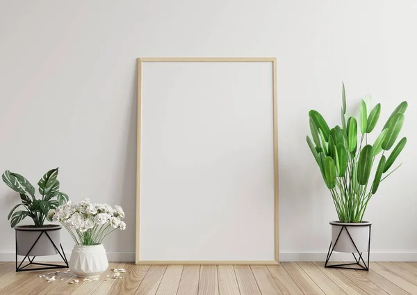 Mock up photo frame in the room, white wall on the wooden floor, beautiful pattern, decorated with plants on the side.3d rendering