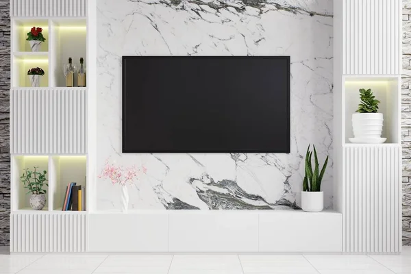 Oturma odasındaki mermer duvarda, modern bir televizyon dolabı ile dekore edilmiş, raflara saksı bitkileri yerleştirilmiş, ve arka plan olarak da tuğla bir duvar.
