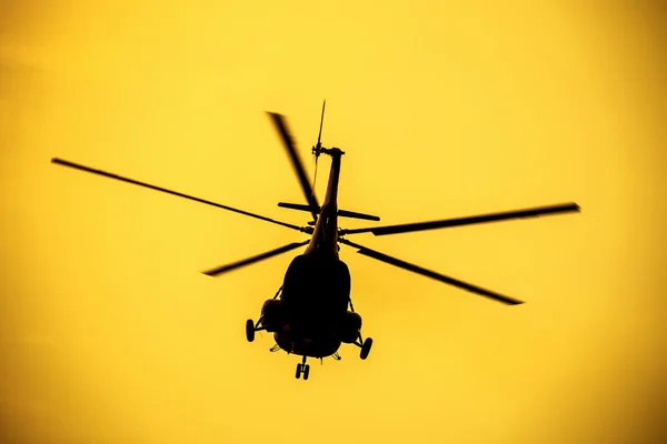 Silhouette of the military helicopter  moving into sky — Stock Photo, Image