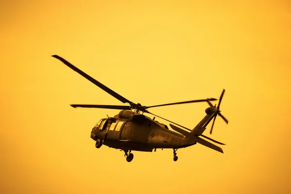 Silhouette of the military helicopter  moving into sky — Stock Photo, Image