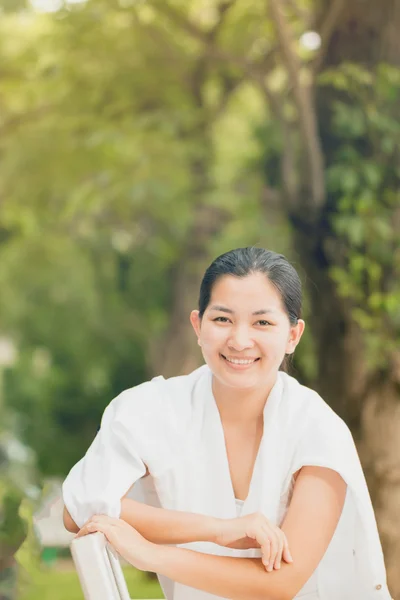 Young asian woman relaxing outdoors looking happy and smiling — Stock Photo, Image