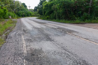 Highlighting need for road repairs in rural areas to enhance safety and accessibility.