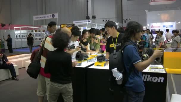 People all of ages visiting and buy the camera or accessories for photography in Photo Fair 2015 Between 25-29 November 2015 at BITEC in Bangkok, Thailand — Stock Video