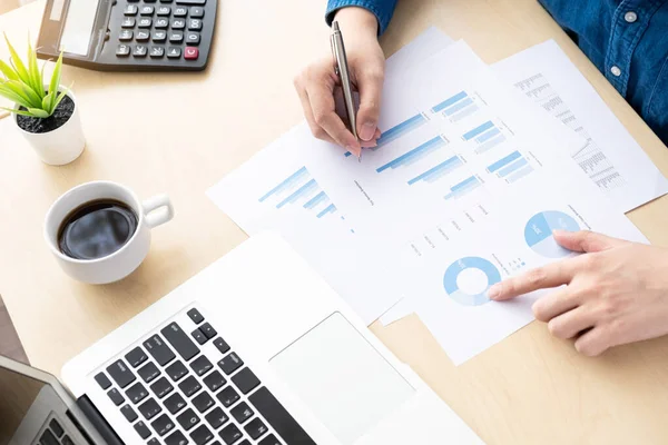 Businessman is inspecting and checking the business reports graphs to audit the financial reports. Analyzing the revenue and auditing the budget concept.