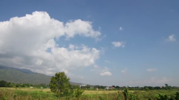 Cloud movement over the agriculture land with mountain background — Stock Video