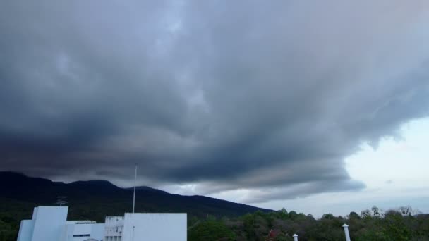 Dark cloud movement over the building and mountain range — Stock Video