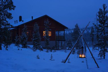House in the snow at dusk. clipart