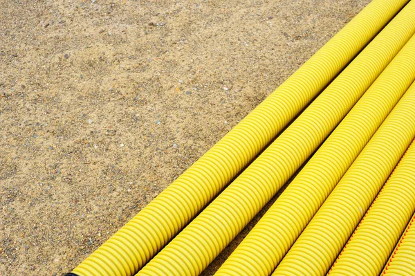 Yellow Plastic Tubes Sand — Stock Photo, Image