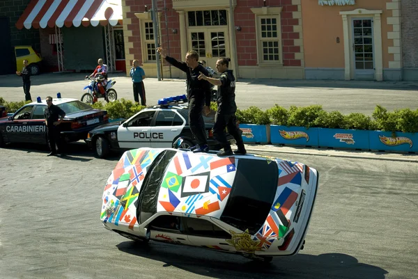 Stuntmans performs a trick on car at the show 
