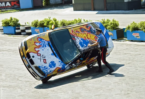 Stuntmans performs a trick on car at the show 