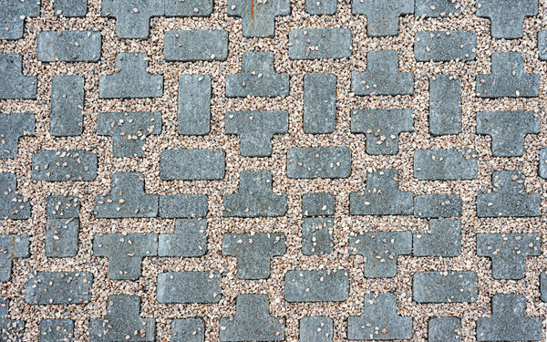 Interlocking paving with gray and white concrete blocks; Concrete products; Construction industry; Paved ground