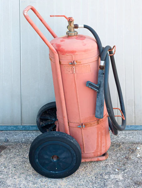 fire extinguishing system in the office. fire cylinders and transport trolley stand by the wall in an office building