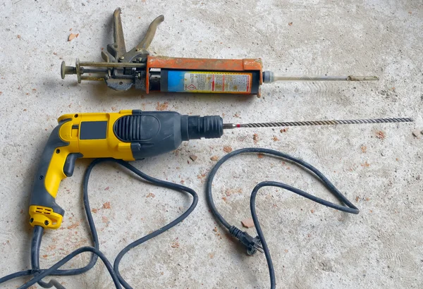 Construction Site: power drill with pistol cartridge resin. — Stock Photo, Image