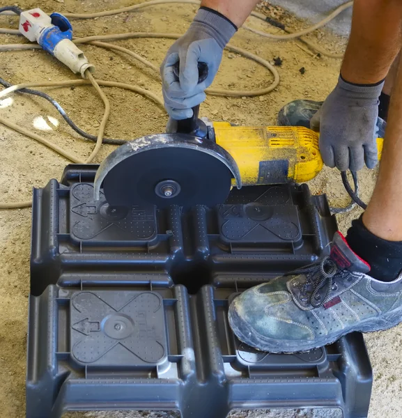 Workers cut a plastic dome with grinder — Stock Photo, Image