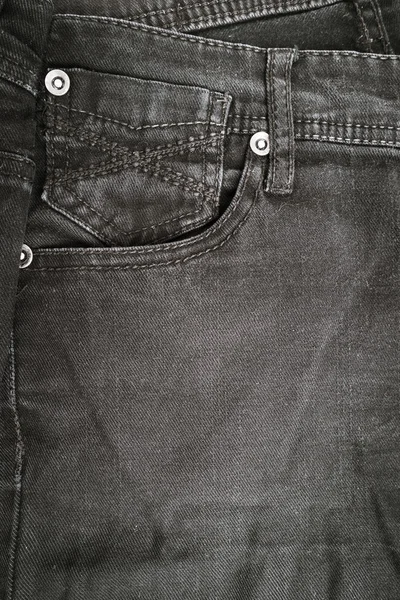 Closeup detail of black denim jeans trousers pocket — Stock Photo, Image