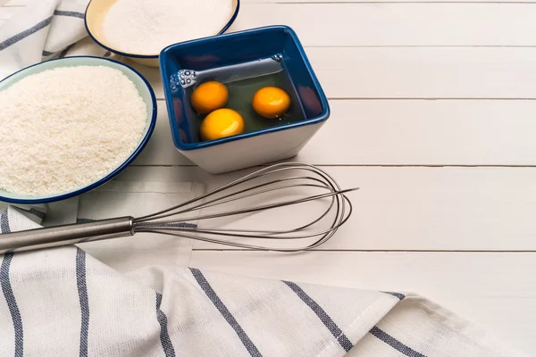 Ingredients for baking a cookies. Recipe for coconut macaroons.