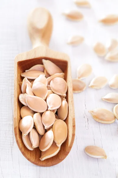 Wooden scoop of pumpkin seeds — Stock Photo, Image