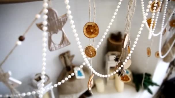 Décorations de Noël en perles, pendentifs décoratifs et agrumes séchés sur la cheminée close-up — Video
