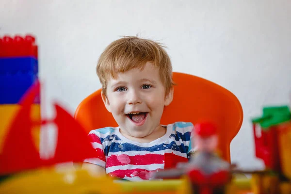 Portrait Blonde Laughing Little Boy Bright Colored Plastic Toys High — Stock Photo, Image