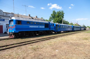 Bershad', Ukraine - July 10, 2021: Narrow gauge locomotive TU2 with a passenger train on the Bershad' railway station