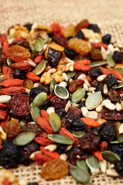 Mix nuts seeds and dry fruits, on a wooden table — Stock Photo, Image