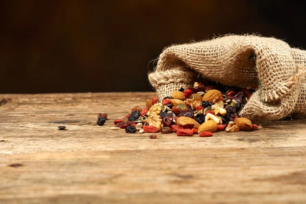 Mix nuts seeds and dry fruits, on a wooden table — Stock Photo, Image