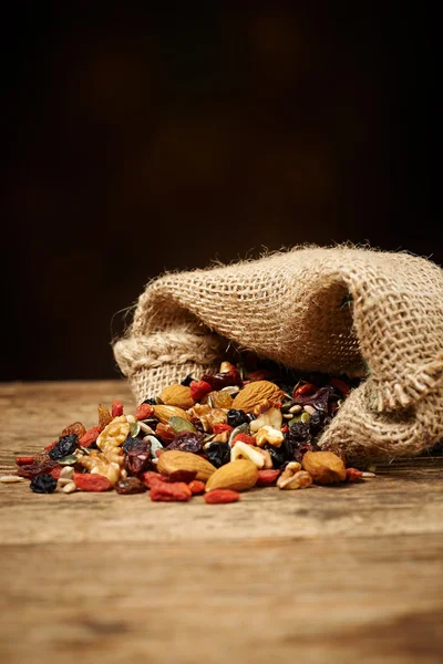 Mix nuts seeds and dry fruits, on a wooden table — Stock Photo, Image