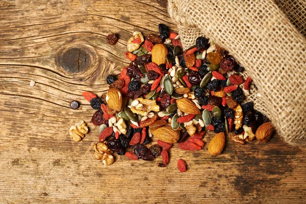 Mix nuts seeds and dry fruits, on a wooden table — Stock Photo, Image