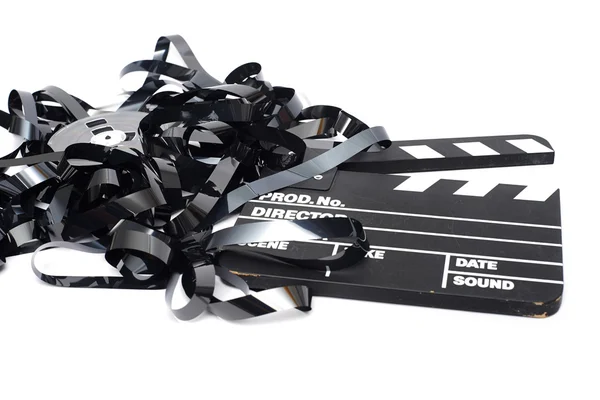 Movie clapper board with video tape on white background — Stock Photo, Image