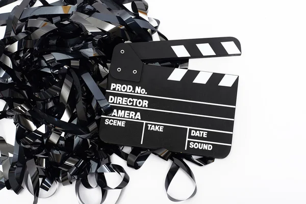Movie clapper board with video tape on white background — Stock Photo, Image