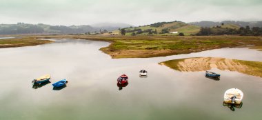 Fishing boat in the estuary of San Vicente de la Barquera. Between Asturias and Cantabria. Spain. Panoramic photography on the coastline clipart