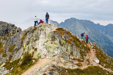 Zakopane, POLAND - August 22, 2015: Group of tourists walk to the top of the Szpiglasowy Wierch in Tatra Mountains.