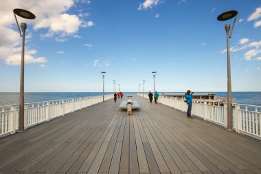 Kolobrzeg, Polonya - 08 Nisan 2016: Kolobrzeg ahşap bir iskele üzerinde yürüyen insanlar. Kolobrzeg Polonya popüler bir turistik yer