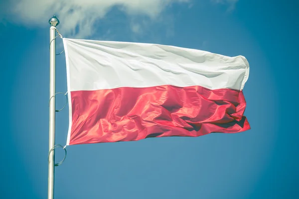 Polish flag on blue sky background, vintage look — Stock Photo, Image