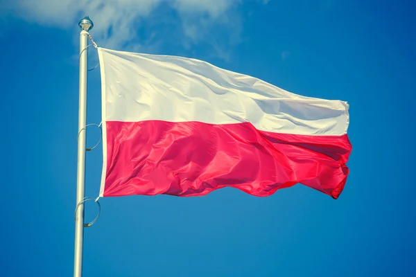 Polish flag on blue sky background, vintage look — Stock Photo, Image