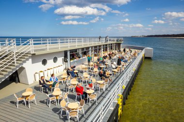 Kolobrzeg, Polonya - 08 Nisan 2016: Kolobrzeg iskelede açık Restoran oturan insanlar