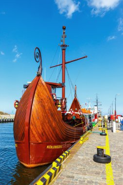 Kolobrzeg, Poland - April 08, 2016: View on harbor in Kolobrzeg with many moored boats and ships. Kolobrzeg is a popular tourist destination clipart