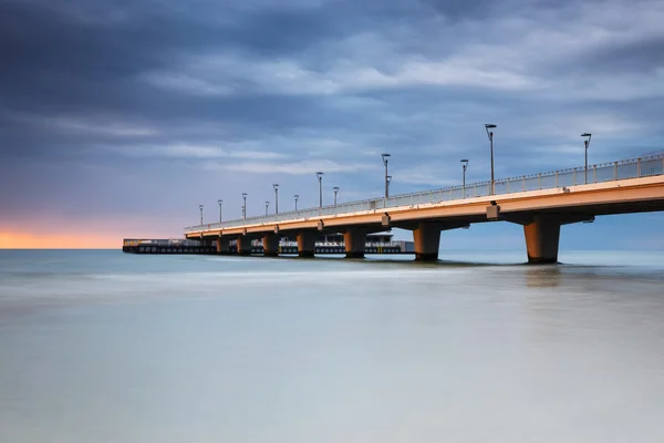 Concrete pier in Kolobrzeg, long exposure shot at sunset — Stock Photo, Image