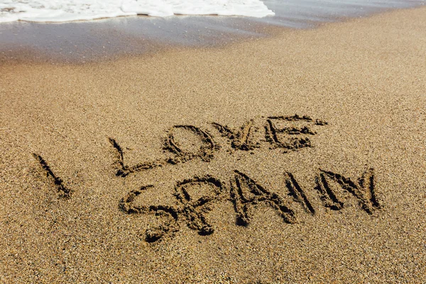 Le parole che amo la Spagna scritte nella sabbia sulla spiaggia — Foto Stock