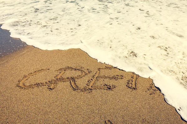 Crete inscription on the sand near the sea — Stock Photo, Image