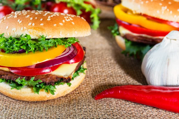 Homemade hamburger with fresh vegetables on cutting board — Stock Photo, Image