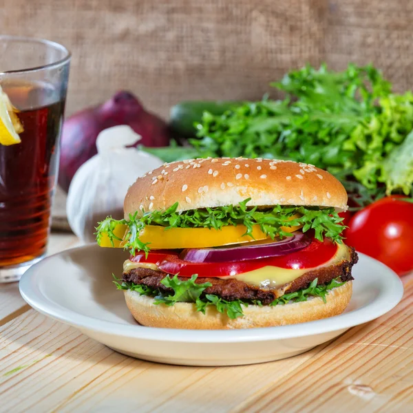 Hamburger and drink with slice of lemon — Stock Photo, Image