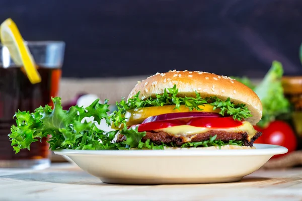 Hamburger and drink with slice of lemon — Stock Photo, Image