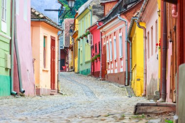 Medieval street view in Sighisoara founded by saxon colonists in clipart