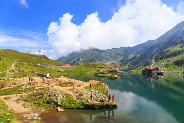 BALEA LAKE, ROMANIA - JULY 21: Unidentified tourists enjoy the sights of Balea Lake at 2,034 m altitude on July 21, 2014 in  Fagaras Mountains, Romania. — Stock Photo, Image